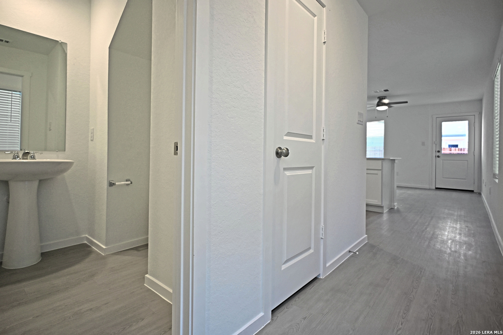 6730 Marble Ridge Elmendorf, TX 78112 - Photo 3 of 17 a view of a hallway with wooden floor