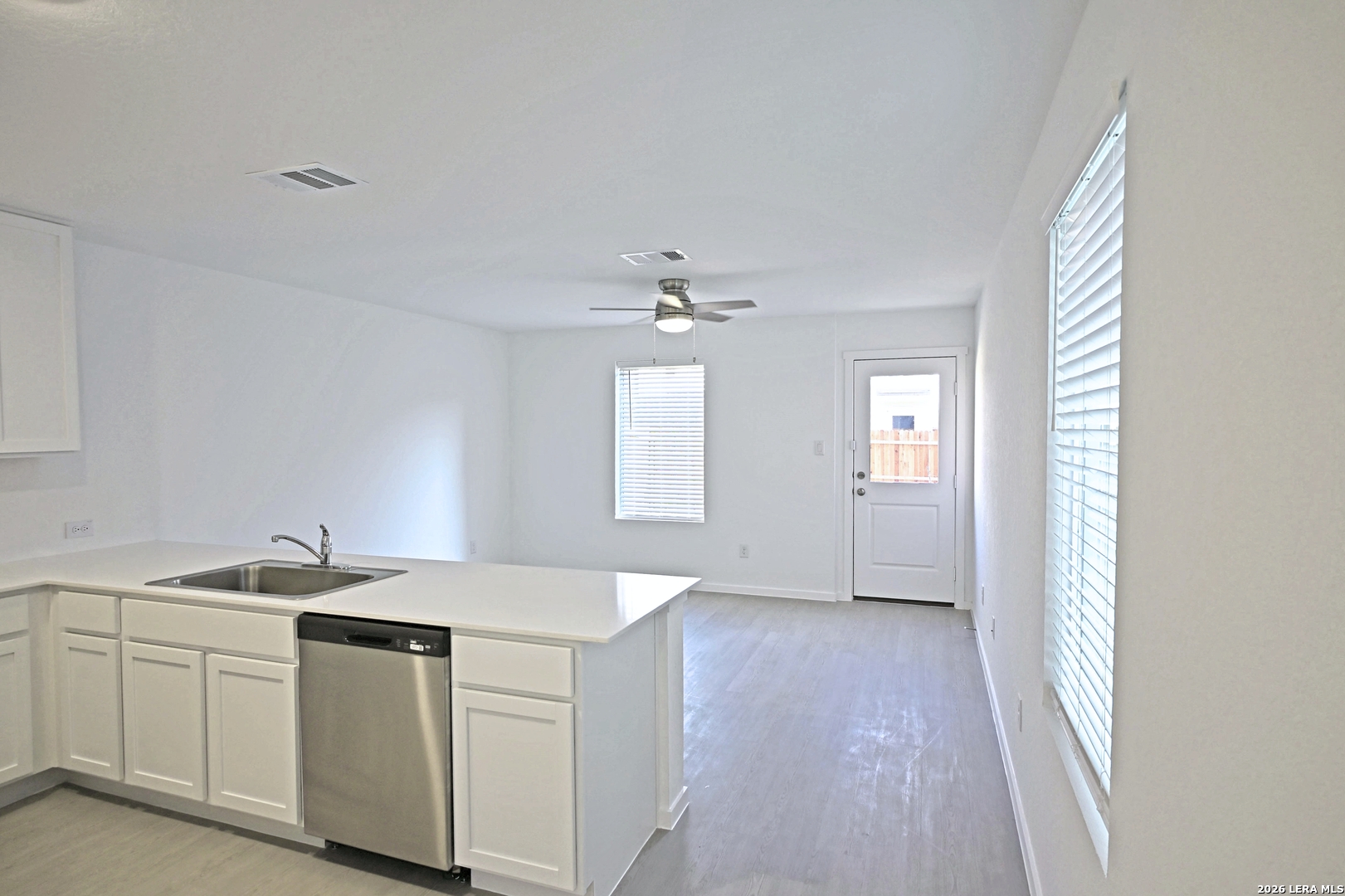 6730 Marble Ridge Elmendorf, TX 78112 - Photo 4 of 17 a view of a kitchen with a sink dishwasher and wooden floor
