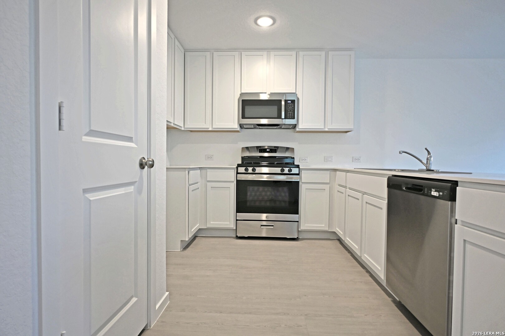 6730 Marble Ridge Elmendorf, TX 78112 - Photo 5 of 17 a kitchen with stainless steel appliances a stove sink and microwave