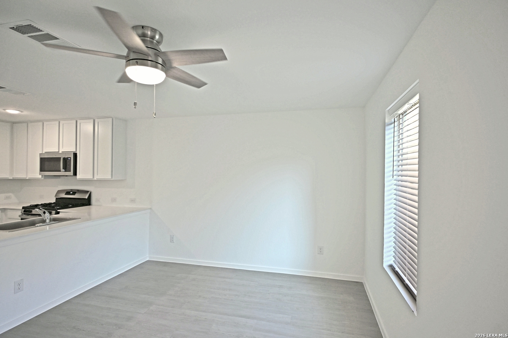 6730 Marble Ridge Elmendorf, TX 78112 - Photo 6 of 17 a view of a kitchen with a dishwasher cabinets and a window