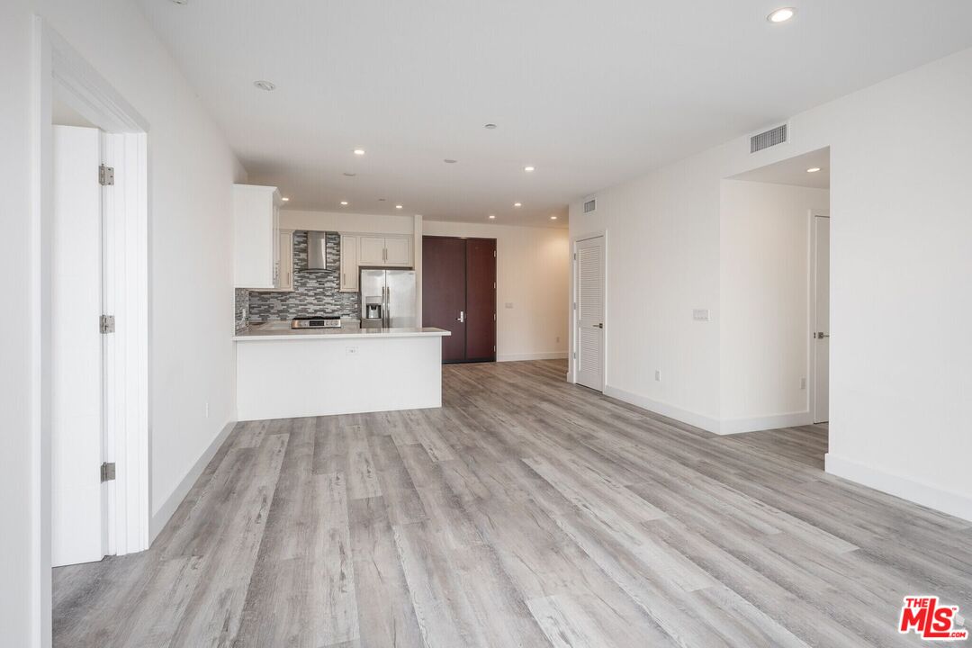 1237 South Holt Avenue, Unit 205 Los Angeles, CA 90035 - Photo 13 of 29 a view of kitchen cabinet and wooden floor