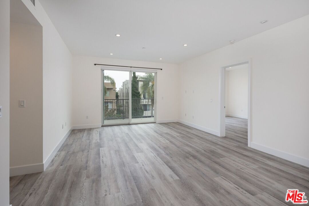 1237 South Holt Avenue, Unit 205 Los Angeles, CA 90035 - Photo 17 of 29 wooden floor in an empty room with a window