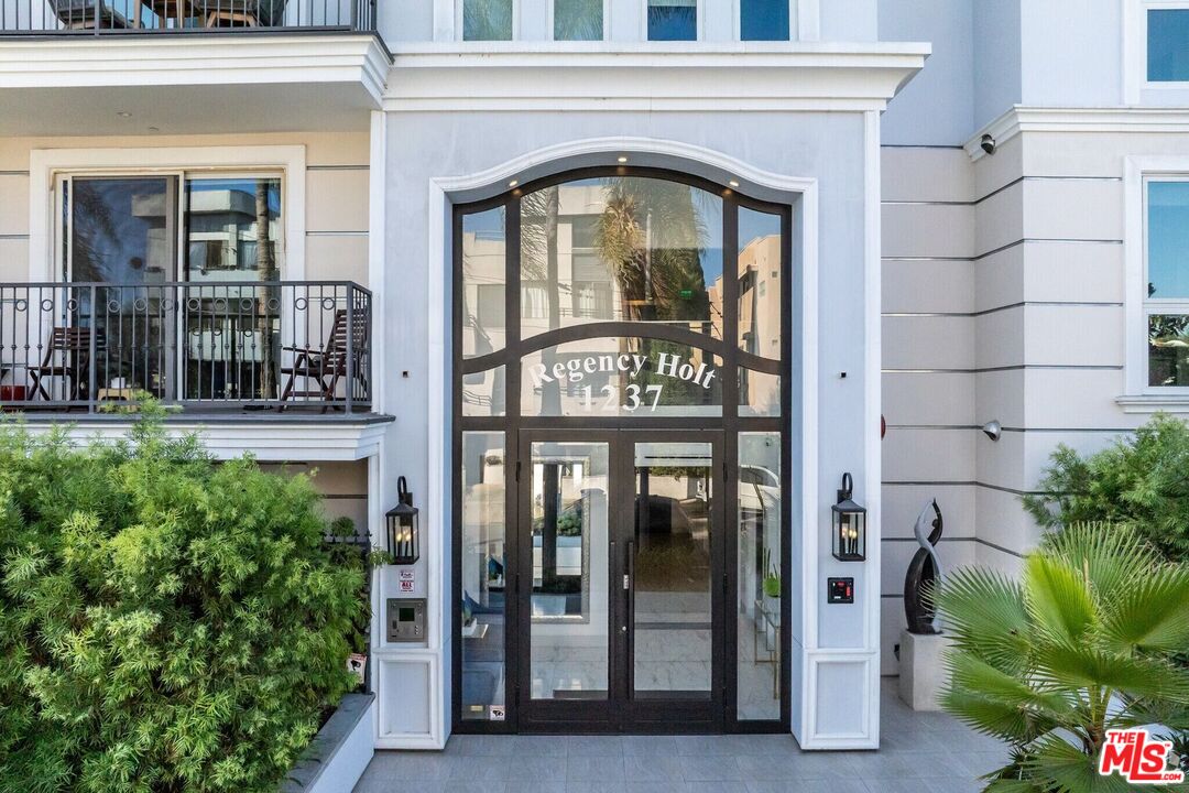 1237 South Holt Avenue, Unit 205 Los Angeles, CA 90035 - Photo 2 of 29 a front view of a building with a glass door