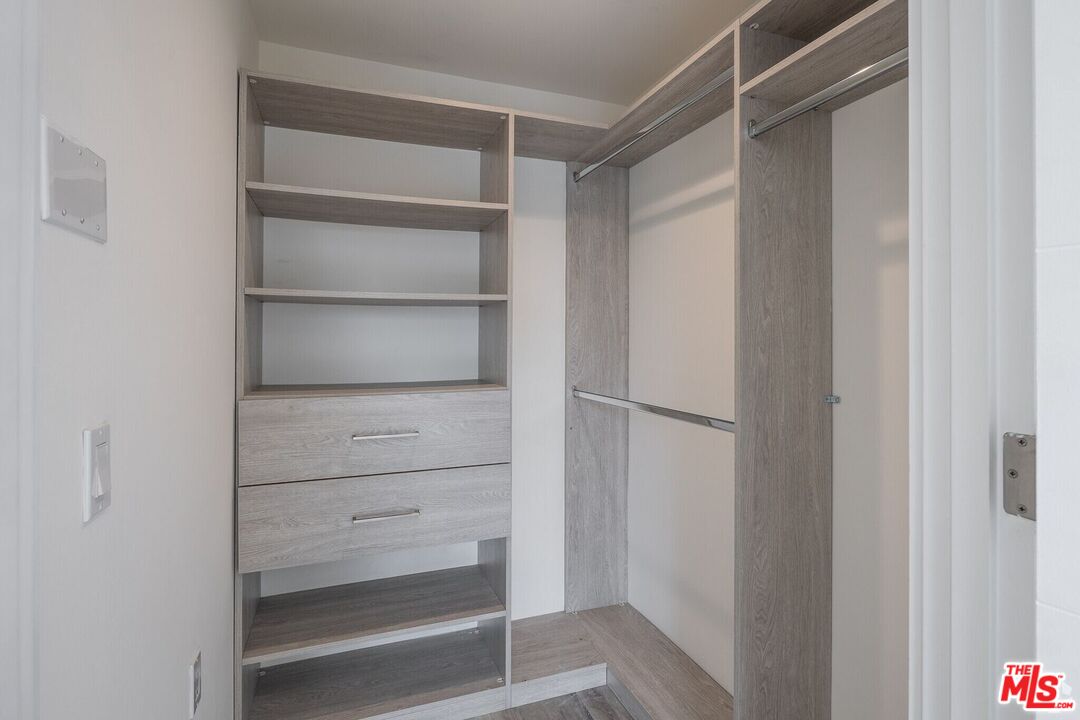 1237 South Holt Avenue, Unit 205 Los Angeles, CA 90035 - Photo 22 of 29 a view of walk in closet with empty racks