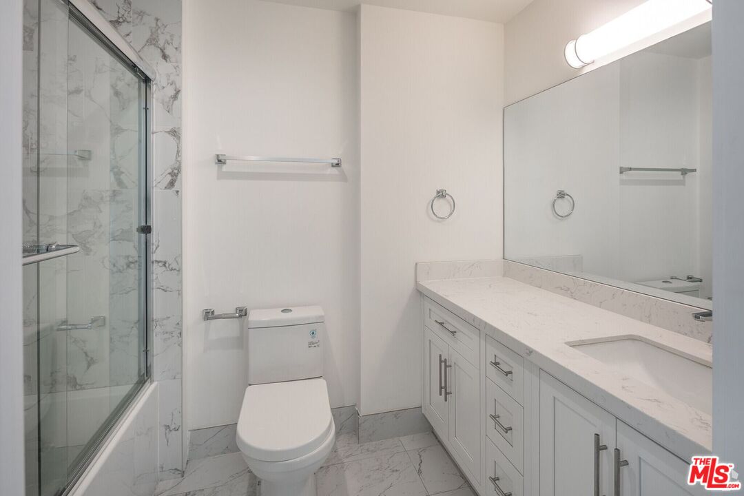1237 South Holt Avenue, Unit 205 Los Angeles, CA 90035 - Photo 24 of 29 a bathroom with a sink a toilet and shower