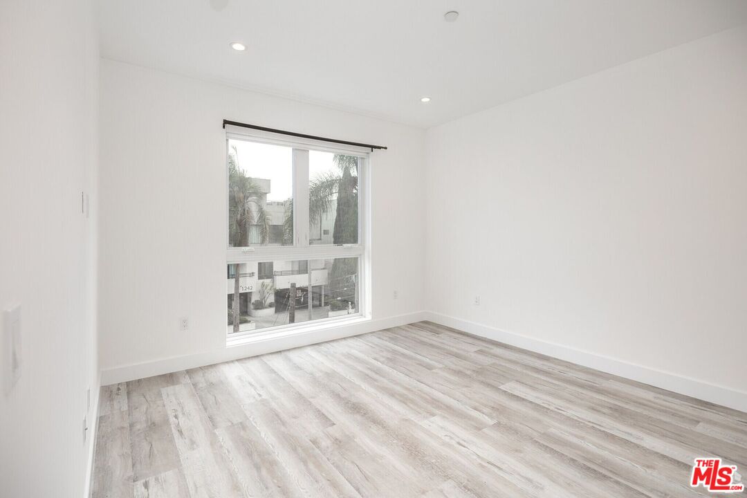 1237 South Holt Avenue, Unit 205 Los Angeles, CA 90035 - Photo 25 of 29 an empty room with large window