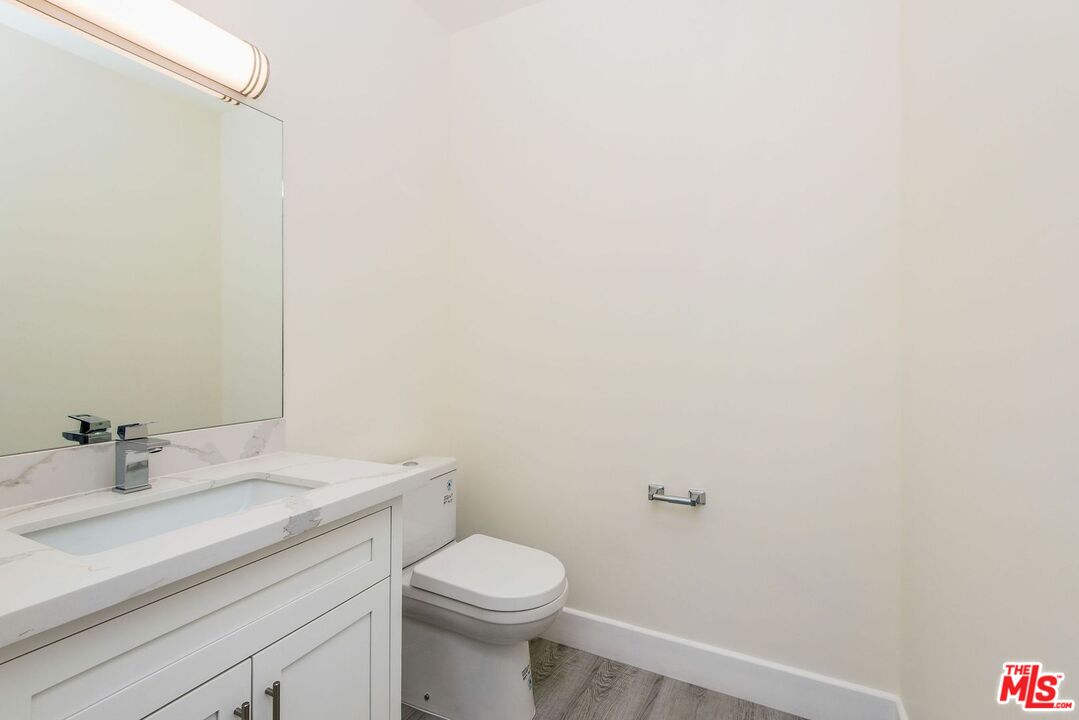 1237 South Holt Avenue, Unit 205 Los Angeles, CA 90035 - Photo 26 of 29 a bathroom with a sink a toilet and shower