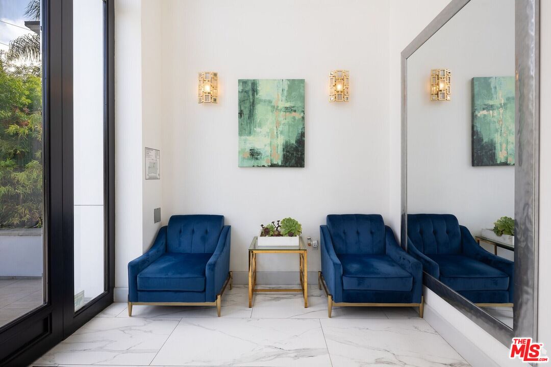 1237 South Holt Avenue, Unit 205 Los Angeles, CA 90035 - Photo 5 of 29 a living room with furniture and a window