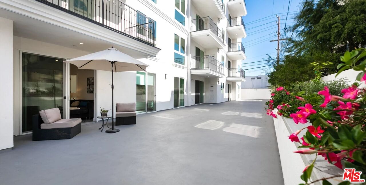 1237 South Holt Avenue, Unit 205 Los Angeles, CA 90035 - Photo 7 of 29 a view of lobby with furniture and flowers