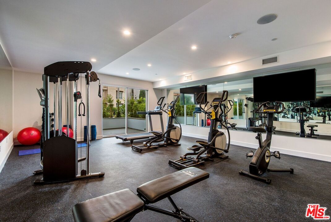 1237 South Holt Avenue, Unit 205 Los Angeles, CA 90035 - Photo 8 of 29 a view of a room with gym equipment