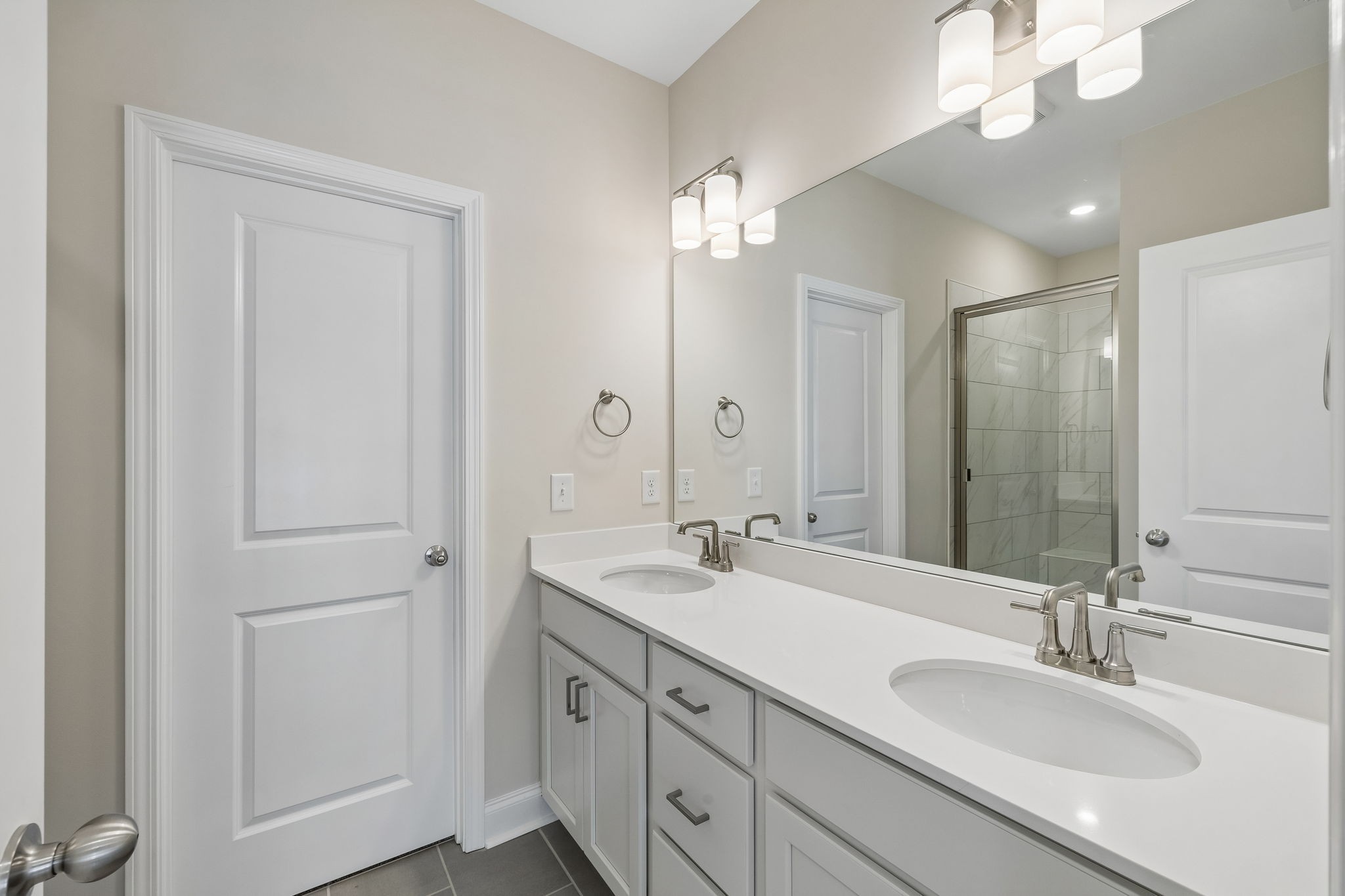 3215 Tasker Drive Antioch, TN 37013 - Photo 22 of 53 a bathroom with a double vanity sink and a mirror
