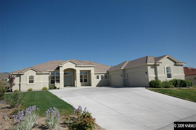 6983 Peacepipe Court Reno, NV 89511 - Photo 1 of 7 a front view of a house with a garden