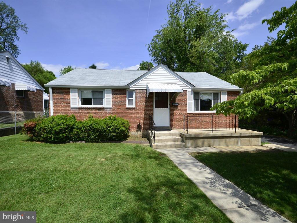 12833 Flack Street Silver Spring, MD 20906 - Photo 1 of 30 a front view of a house with a yard