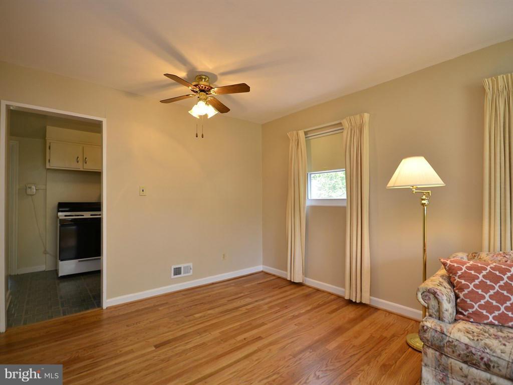 12833 Flack Street Silver Spring, MD 20906 - Photo 5 of 30 a bedroom with bed and a chandelier
