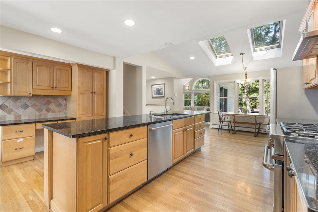 44 Whittier Road Wellesley, MA 02481 - Photo 3 of 34 a kitchen with granite countertop a stove and white cabinets