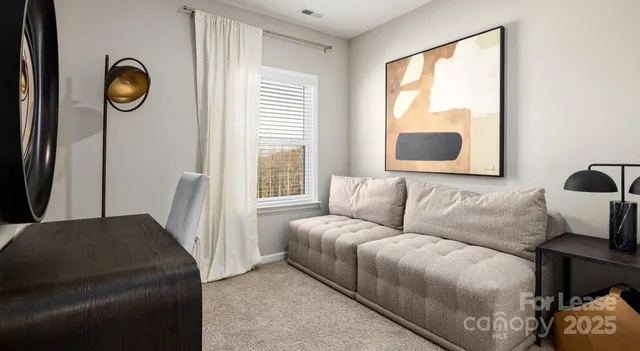 a living room with a couch and a window