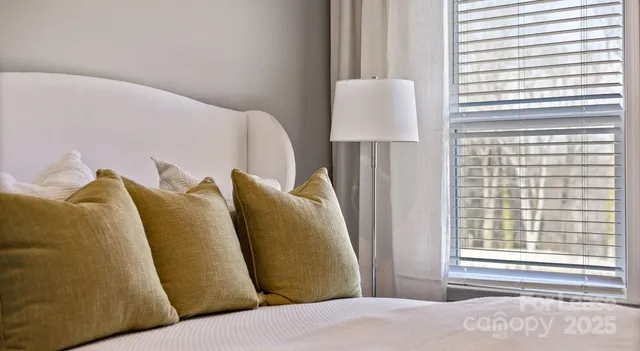 a bed room with a bed and a chair