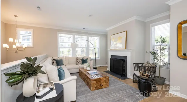 a living room with furniture fireplace and window