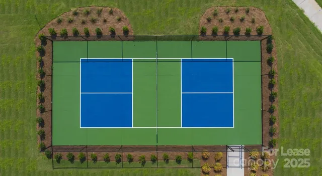 an aerial view of a house with a yard table and chairs