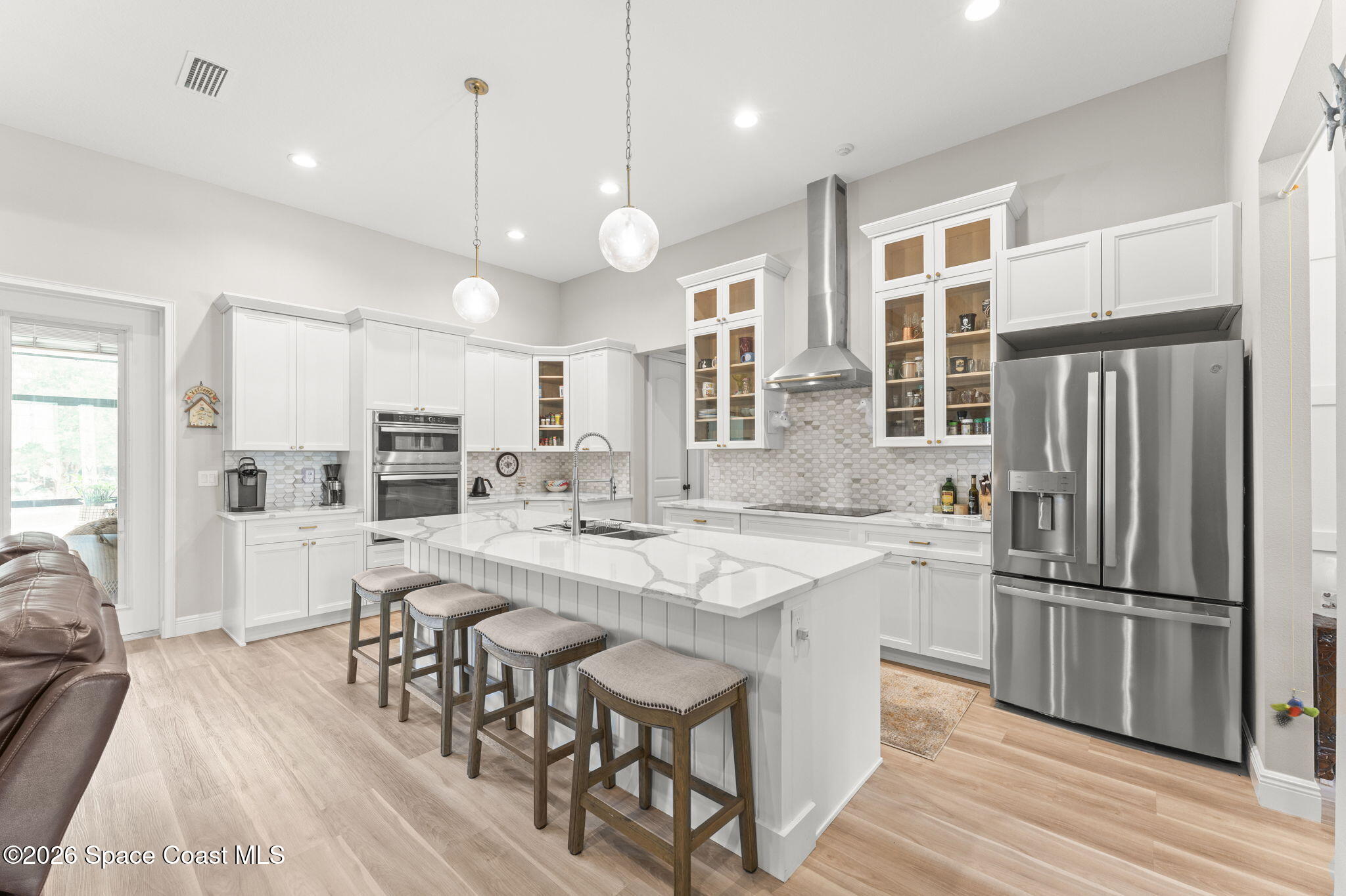 1740 Ford Road Mims, FL 32754 - Photo 13 of 43 a kitchen with stainless steel appliances a dining table chairs stove refrigerator and cabinets