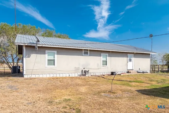 a view of a house with a backyard