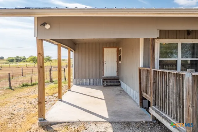 a view of a balcony with a floor to ceiling window and wooden floor
