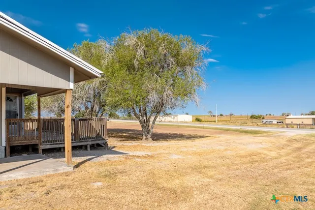 a view of a house with wooden fence