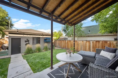 a view of a patio with a table chairs and a backyard