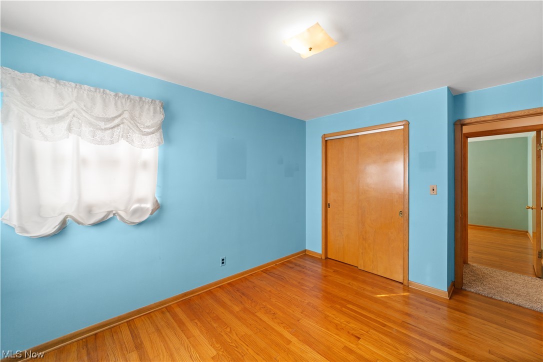 7228 Maplewood Road Parma, OH 44130 - Photo 14 of 30 Unfurnished bedroom featuring light hardwood floors and a closet