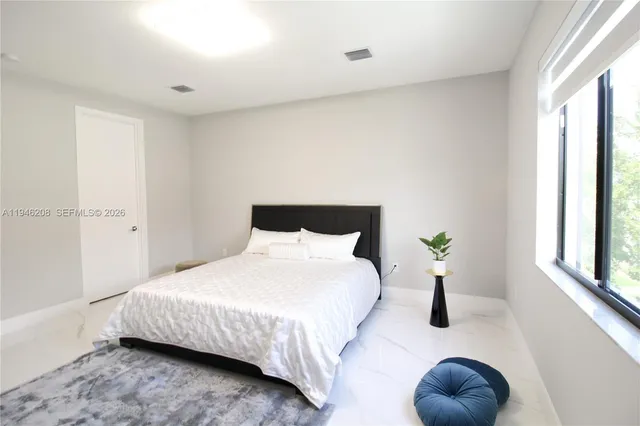 a bedroom with a bed and window