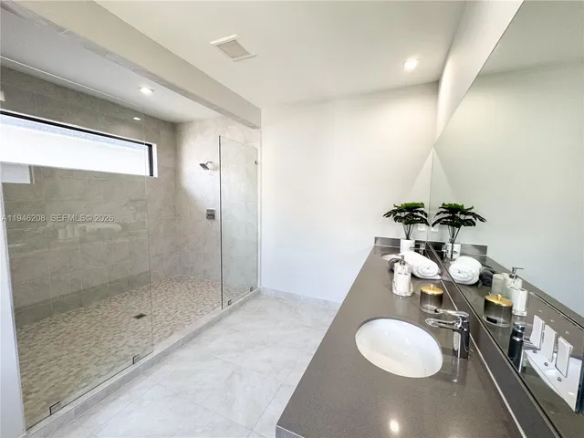 a bathroom with a sink a toilet and mirror