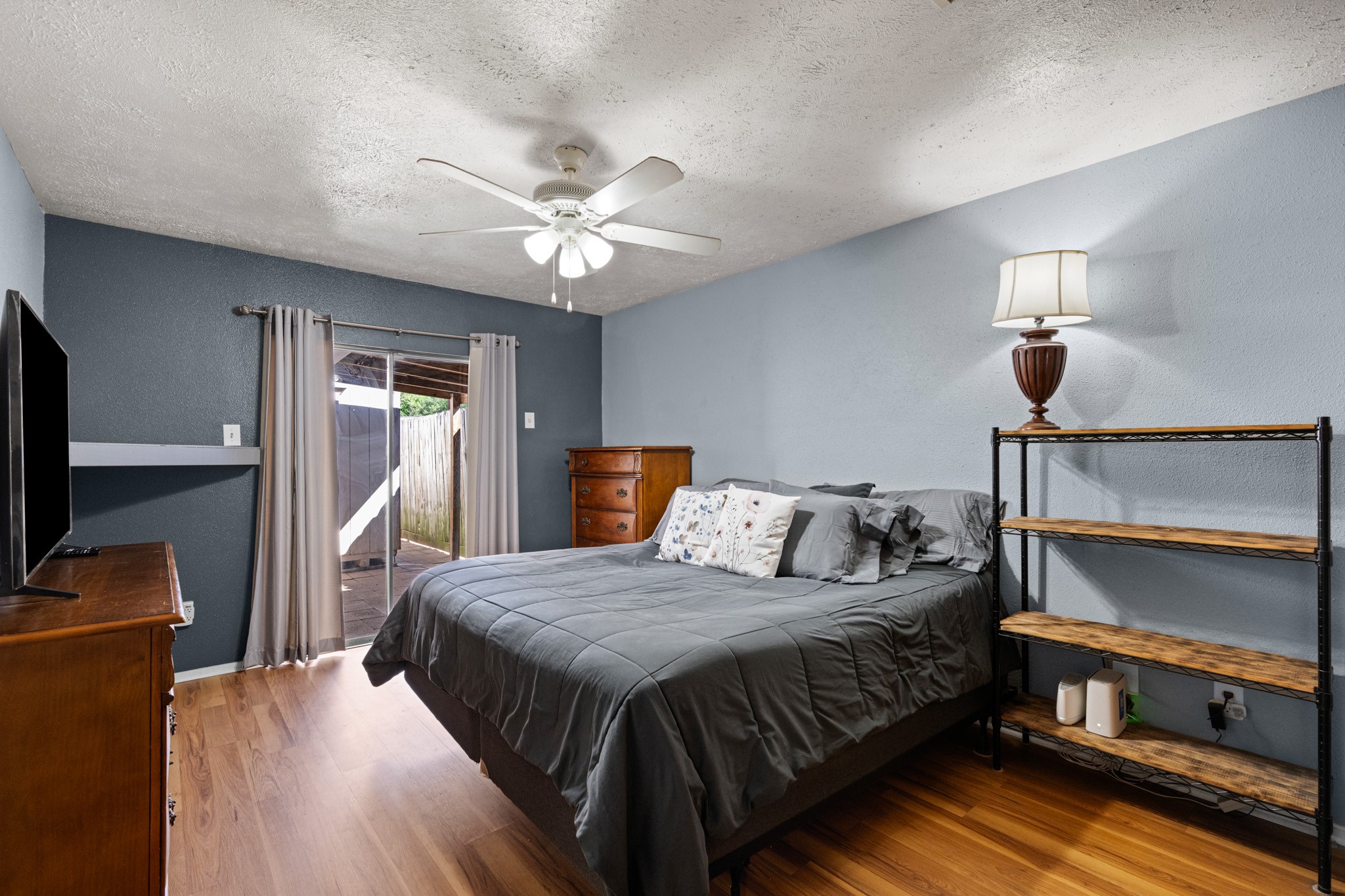 1804 Spruce Drive Rosenberg, TX 77471 - Photo 15 of 29 a bedroom with a bed and a chandelier