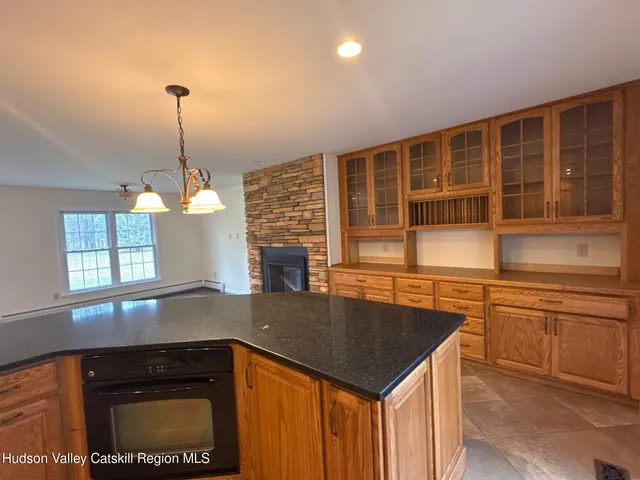 a view of a kitchen with granite countertop cabinets