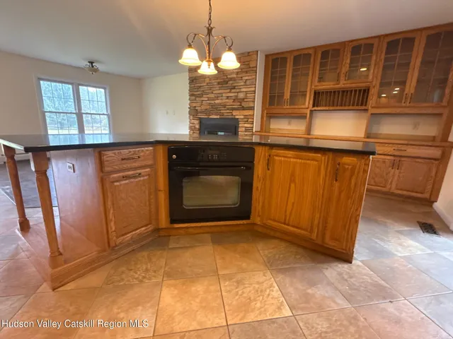 a kitchen with stainless steel appliances granite countertop a sink and dishwasher a refrigerator with wooden cabinets