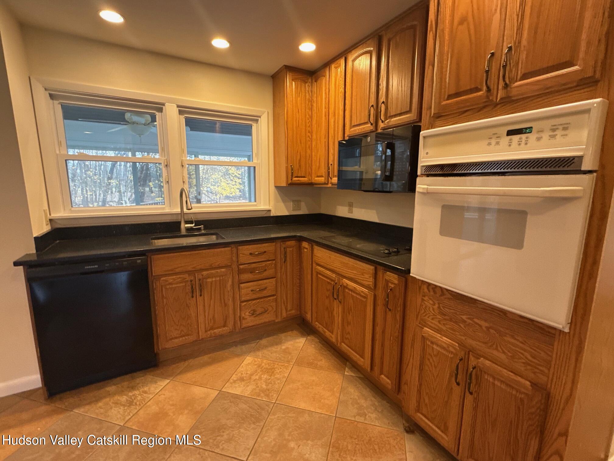 20 Van Orden Road Milton, NY 12547 - Photo 13 of 29 a kitchen with stainless steel appliances granite countertop a sink and dishwasher a refrigerator with wooden cabinets