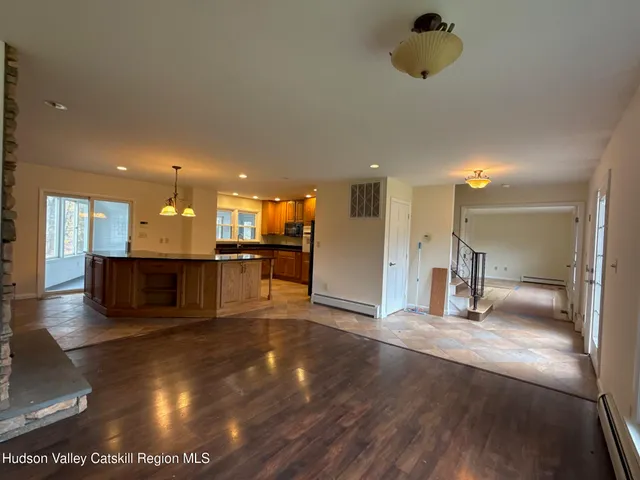 a view of kitchen with refrigerator and windows