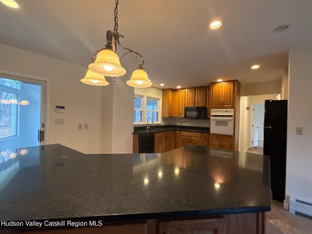 a large bathroom with a large mirror vanity and shower