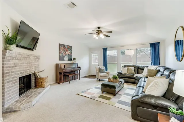 a living room with furniture fireplace and flat screen tv