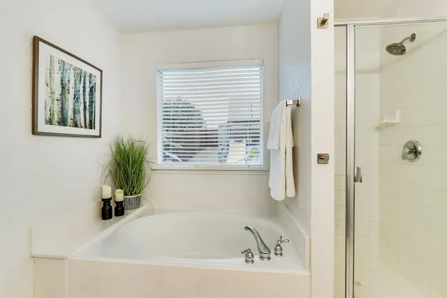 a white bath tub sitting next to a window