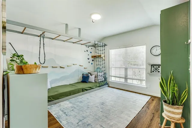 a view of a room that has a bed and a window