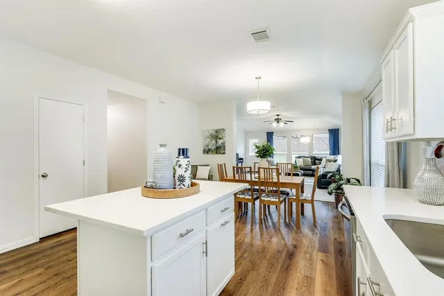 a view of a dining room with furniture and wooden floor