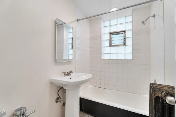 a bathroom with a sink a bathtub and a shower