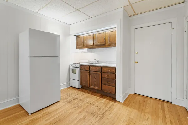a view of a kitchen with a sink and a refrigerator