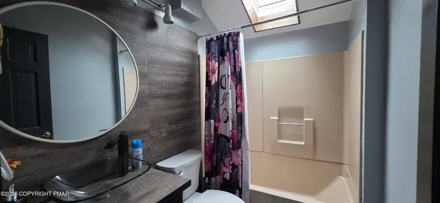 a bathroom with a mirror and a shower