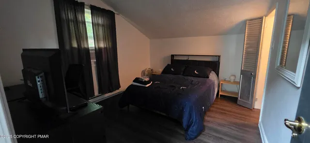 a bed room with a bed and a mirror