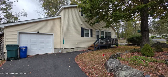 a view of a house with a yard and garage