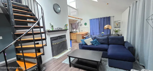 a living room with furniture a rug and a window