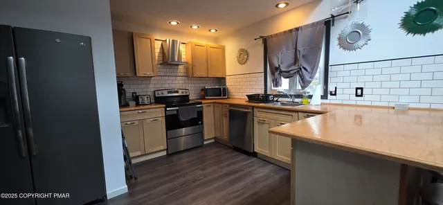 a kitchen with a sink stove and refrigerator