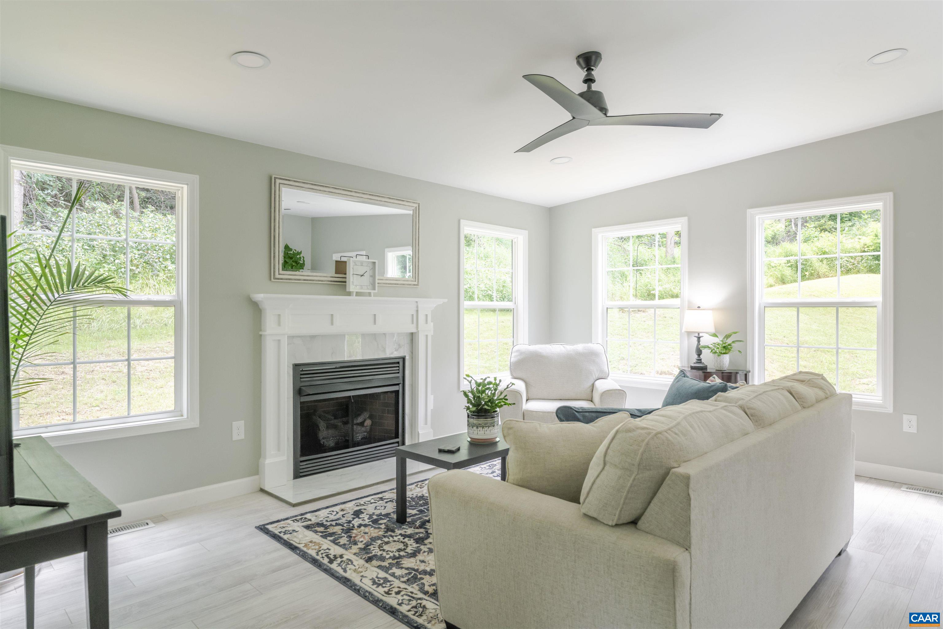 5860 Bearwood Road Crozet, VA 22932 - Photo 27 of 67 a living room with furniture fireplace and window
