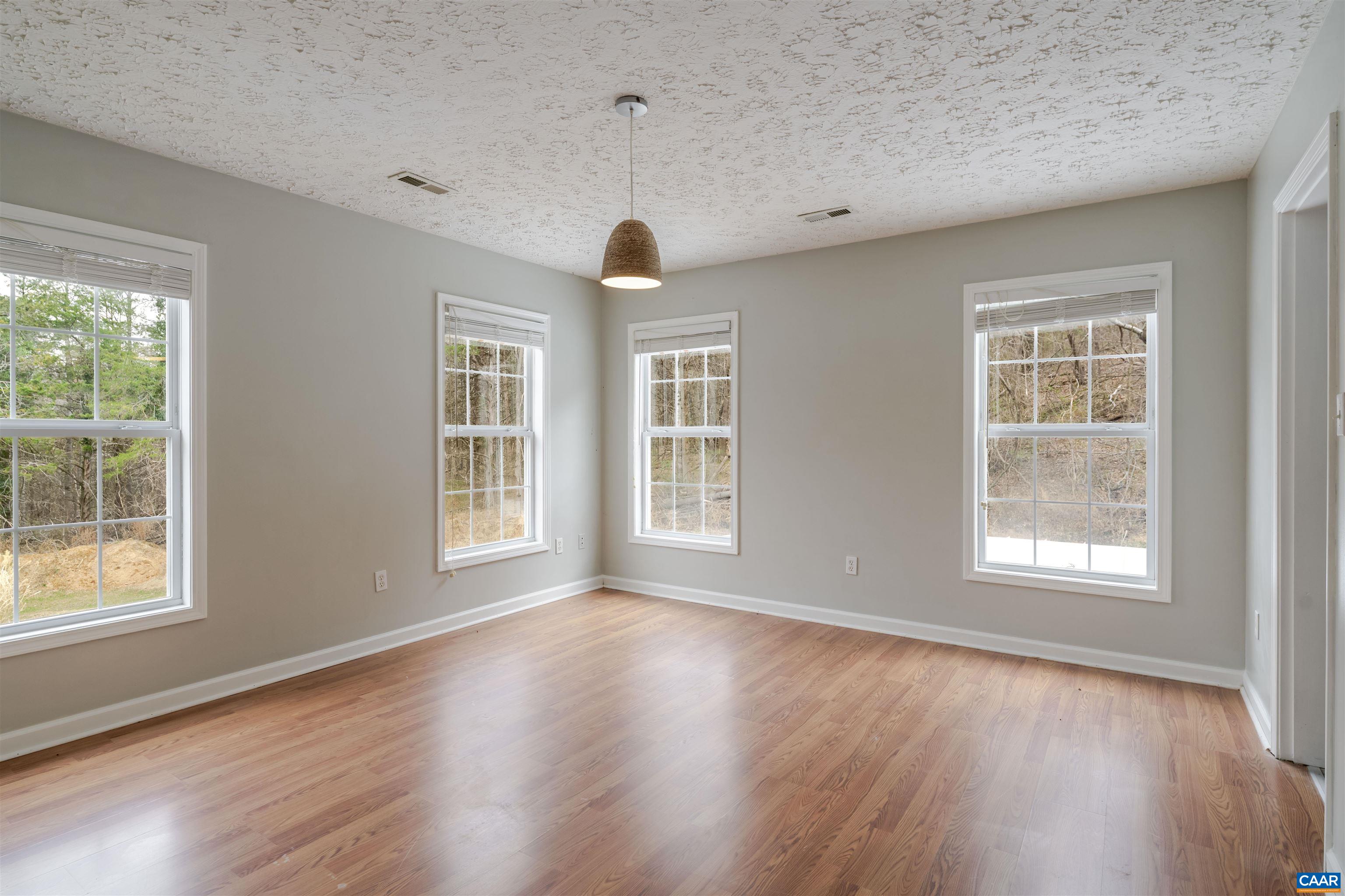 5860 Bearwood Road Crozet, VA 22932 - Photo 31 of 67 a view of an empty room with wooden floor and a window